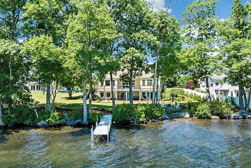 Modern Lake Opechee Home features Sandy Perched Beach and Dock