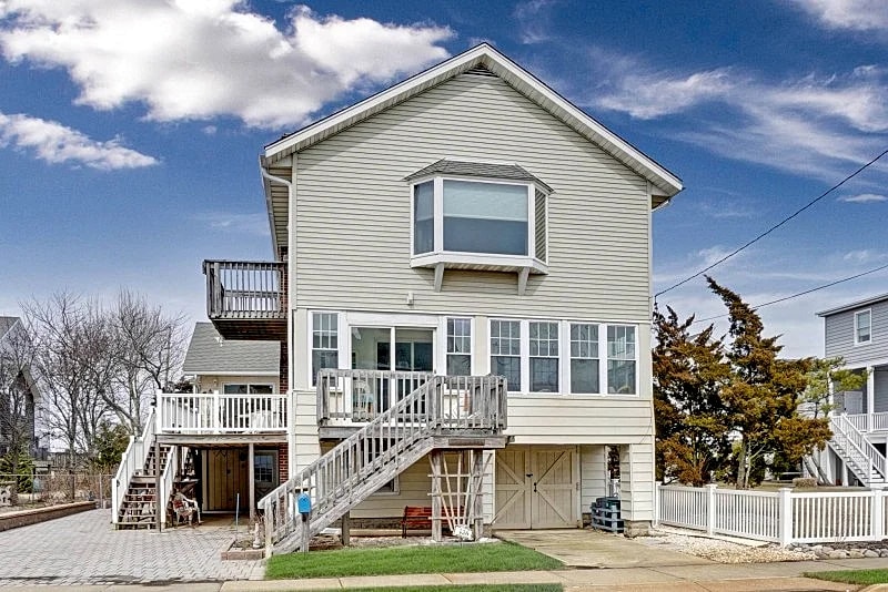 Enjoy magnificent sunsets and panoramic bay views from this unique shore home