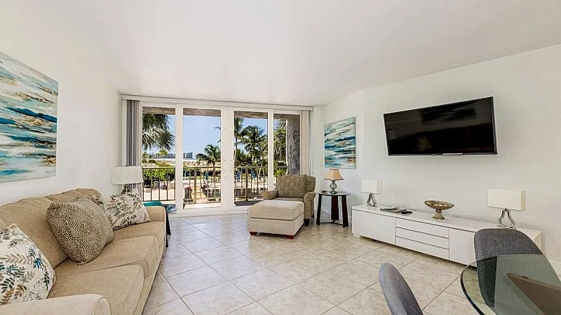 Enjoy tropical pool and beach views from the balcony of this lovely...